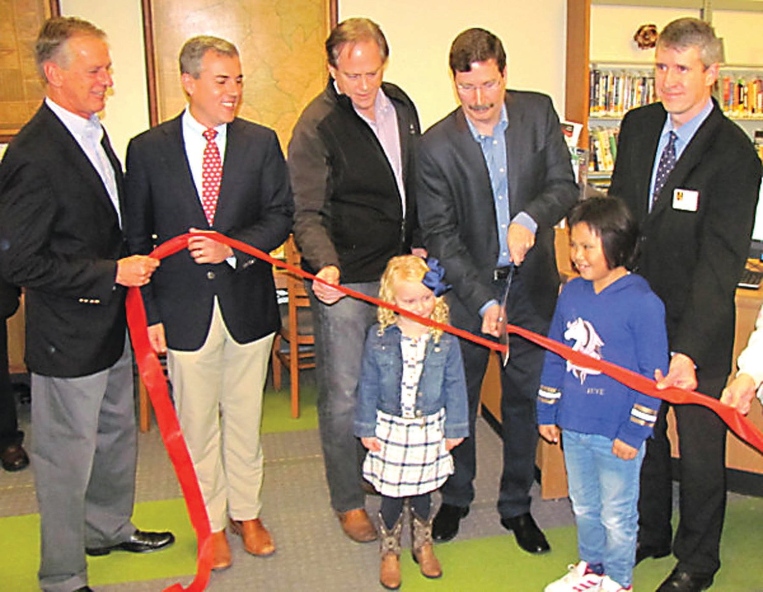 From left, John W. King, John E. Lanza, Matt Holt, Mayor Tim Mathews and James Keehbler join with East Amwell school children to cut the ribbon for the South County Library.