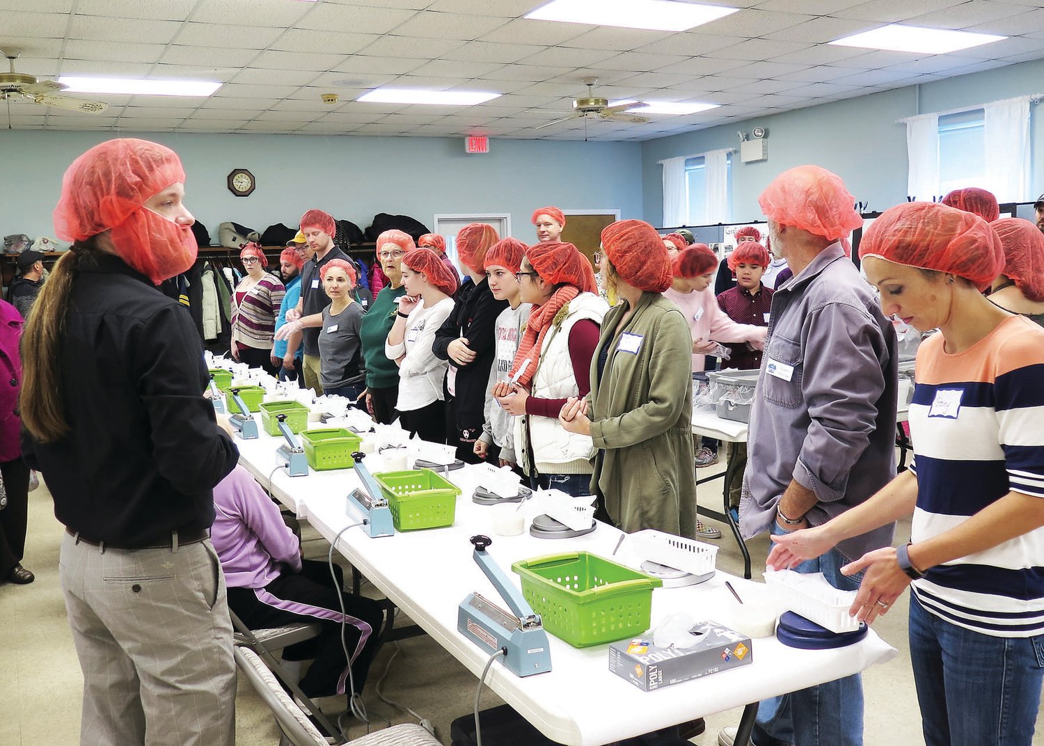 Forest Grove volunteers ready to start weighing and sealing meals for Rise Against Hunger.