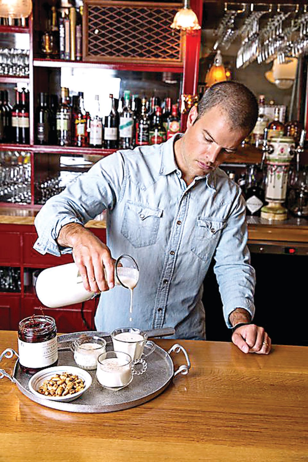 Brooks Reitz, founder of Jack Rudy Cocktail Co., pours his version of George Washington’s alcohol-laced eggnog. Photograph by popularmechanics.com