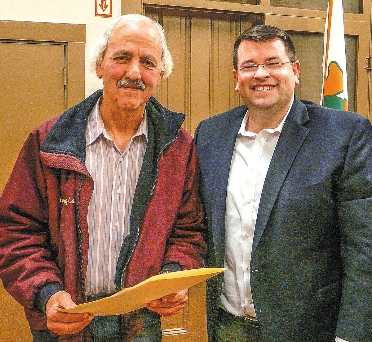 Assistant sewer operator Jerry Case, left, is praised upon the occasion of his retirement by Frenchtown, N.J., Mayor Brad Myhre. He is a 32-year borough employee. Photograph by Rick Epstein.