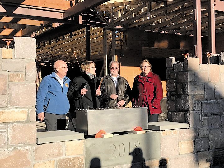 Doylestown Township Supervisors Vice Chairman Rick Colello, Chairwoman Barbara N. Lyons, Supervisor Ken Snyder and Supervisor Jennifer Herring place the time capsule at the new municipal building.  Photograph by Dana M. Eckman