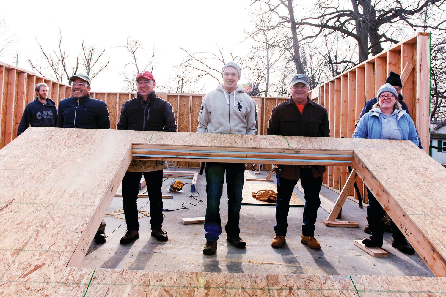 From left are Penn Community Bank directors and team members W. Thomas Lomax, Robert L. Byers, Will Kadri, Bruce Weed and Diane Brown during a build day for the Habitat for Humanity of Bucks County Woodland Park Project in Morrisville on Jan. 4.