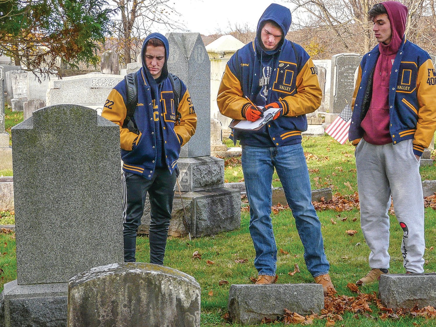 Harvesting data in the Rosemont Cemetery are, from left, Nicolas DiBetta, Jake Norgard and Alejandro Silva. The exercise is called a “cemetery lab.”