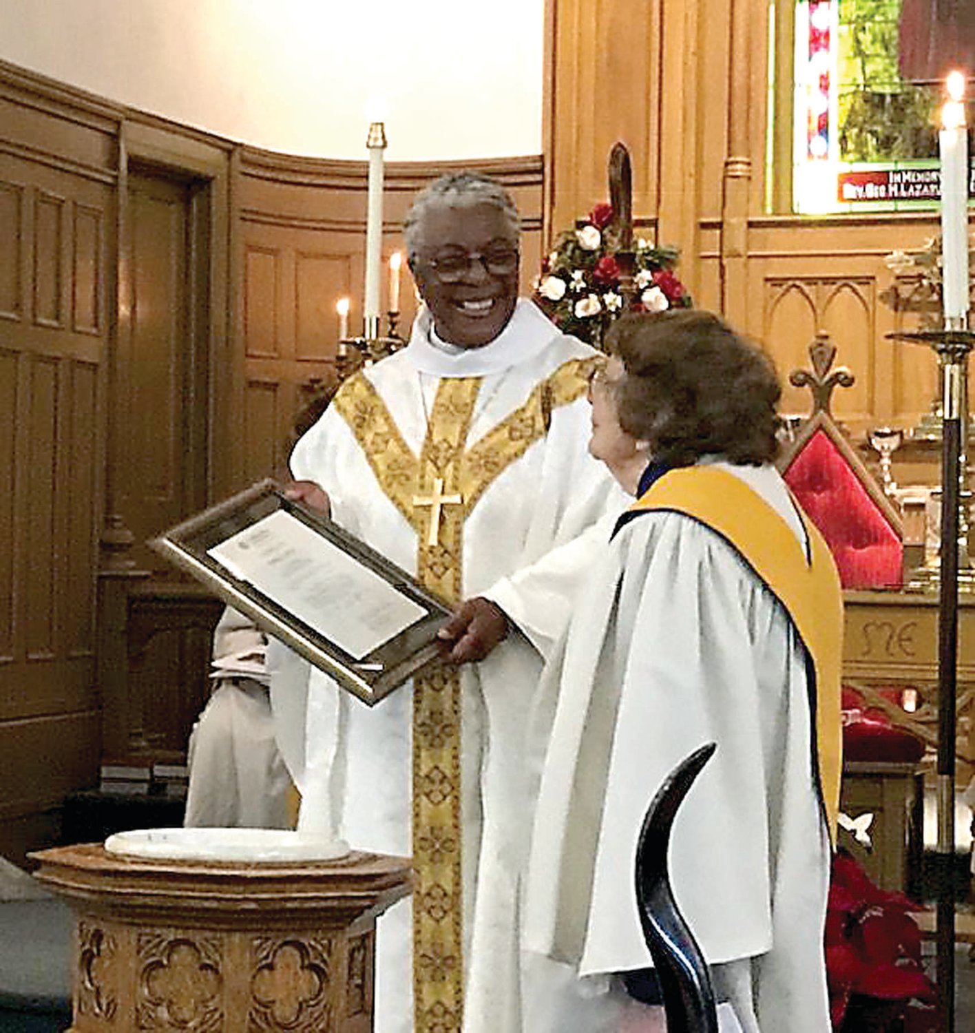 The Rev. Patricia Ann Curtis Davenport, bishop of the Southeastern Pennsylvania Synod of the Evangelical Lutheran Church in America, left presents Martha Fisher, organist-choir director, with a certificate commemorating her 33 years serving as a deacon of St. John’s Evangelical Lutheran Church in Quakertown.
