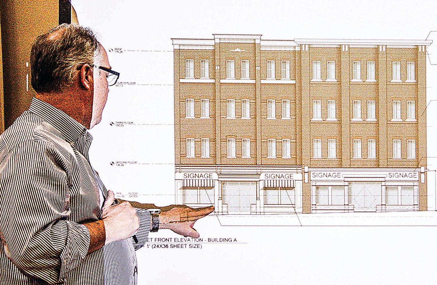“A gift to Frenchtown” will grace Bridge Street. The top three floors will be apartments with retail on the ground floor. It will fit between the Frenchtown Inn and the Odd Fellows building. That’s architect Ralph Fey on the left.“A gift to Frenchtown” will grace Bridge Street. The top three floors will be apartments with retail on the ground floor. It will fit between the Frenchtown Inn and the Odd Fellows building. That’s architect Ralph Fey on the left. Photograph by Rick Epstein.