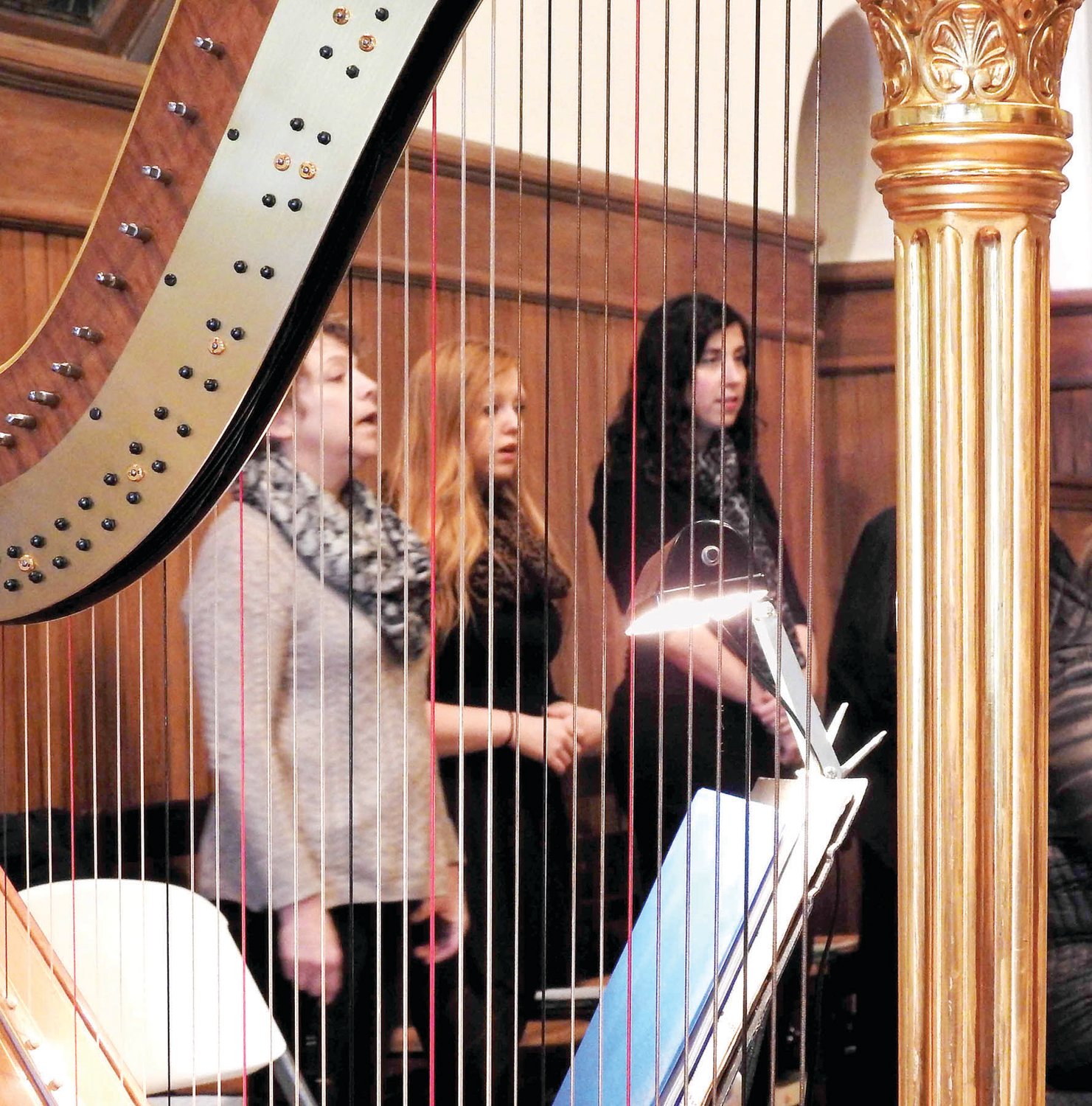 Choir members sing, accompanied by a harp, at Saint Andrew’s Episcopal Church, Lambertville, N.J.