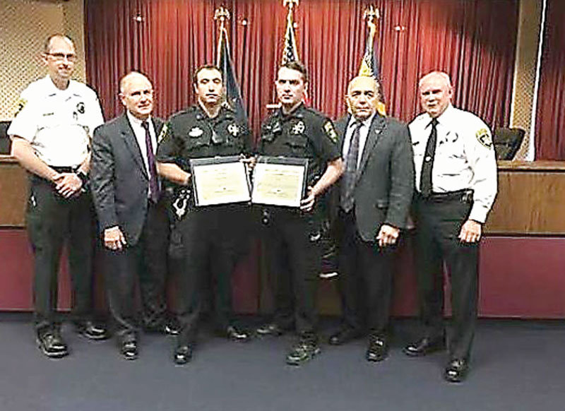 From left. as they are honored by Lycoming County commissioners, second from left, are Chief Deputy Curtis Ulmer, Deputy Christopher Warden, Deputy Cody Barto and Sheriff Mark Lusk. Deputy Nick Labe was also honored.