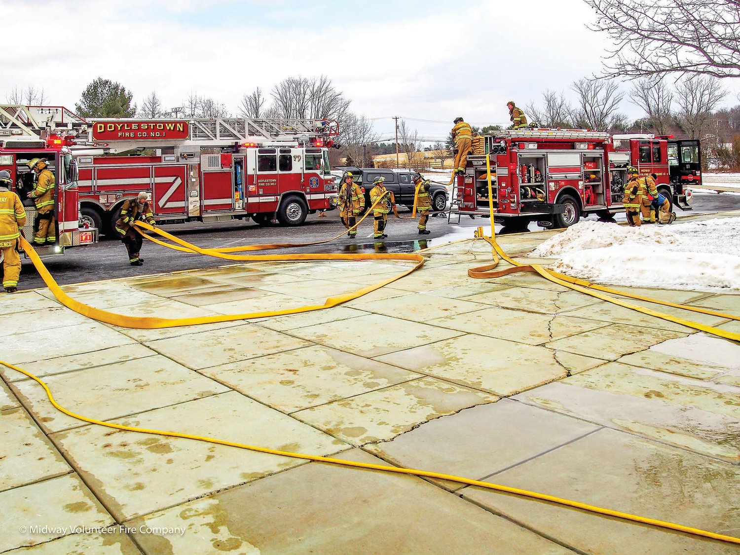 Firefighters work to extinguish a fire that damaged a second-floor classroom at Cold Spring Elementary School in Buckingham. Students and staff were evacuated to a neighboring church; there were no injuries.  Photograph courtesy of Midway Volunteer Fire Company.