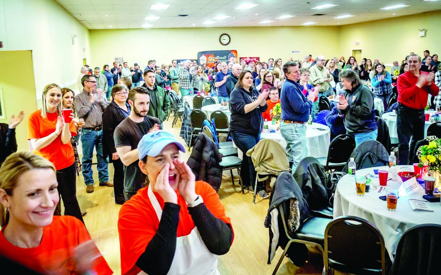 Friends, family and community members give a standing ovation for Steve Cronin, a Midway Volunter Fire Compay firefighter who was diagnosed with ALS in 2018. Photograph by Andrew Smith and Mark Smith.