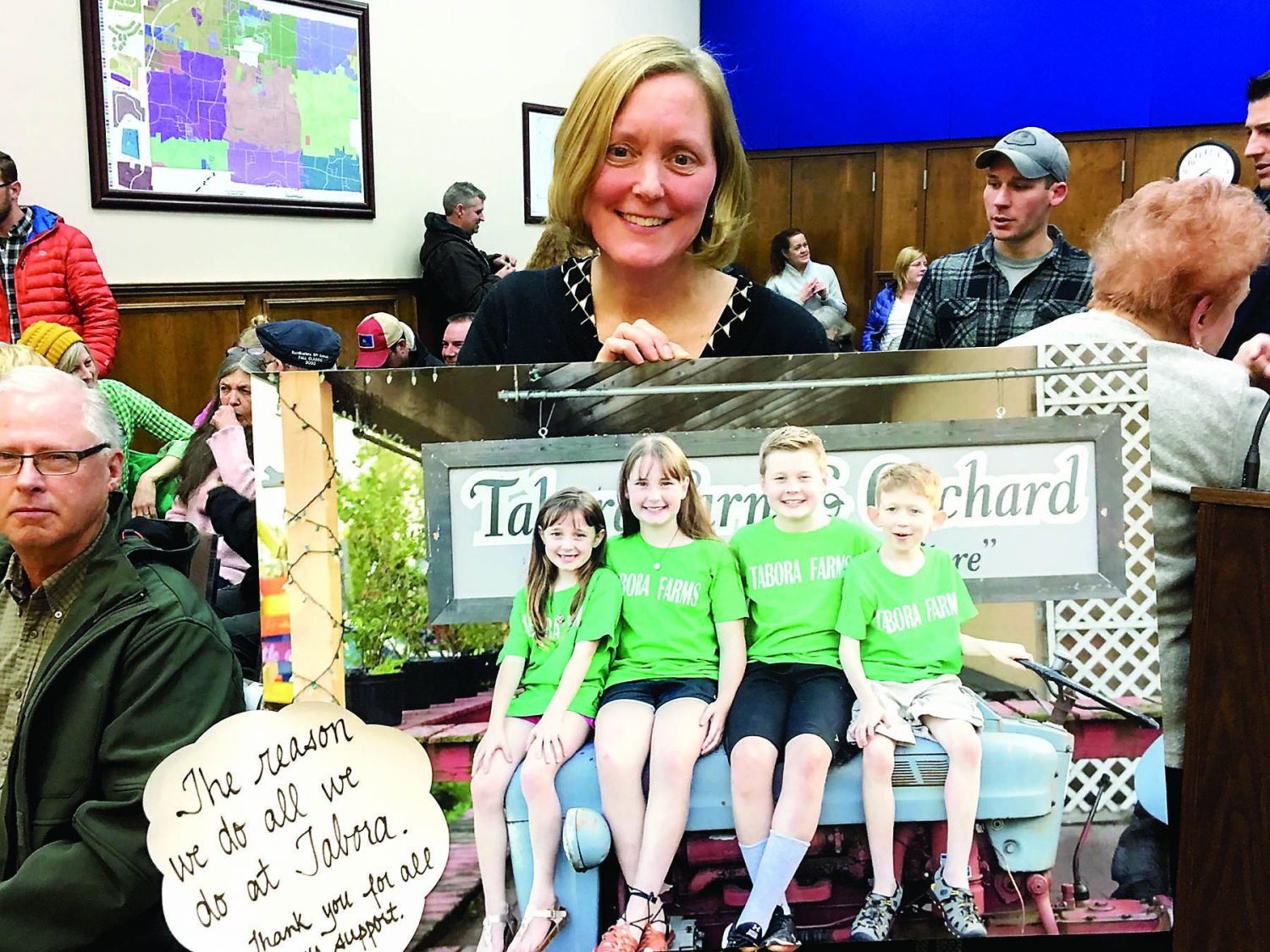 Patricia Torrice of Tabora Farms holds a photo of the Torrice children at a Hilltown Township meeting.