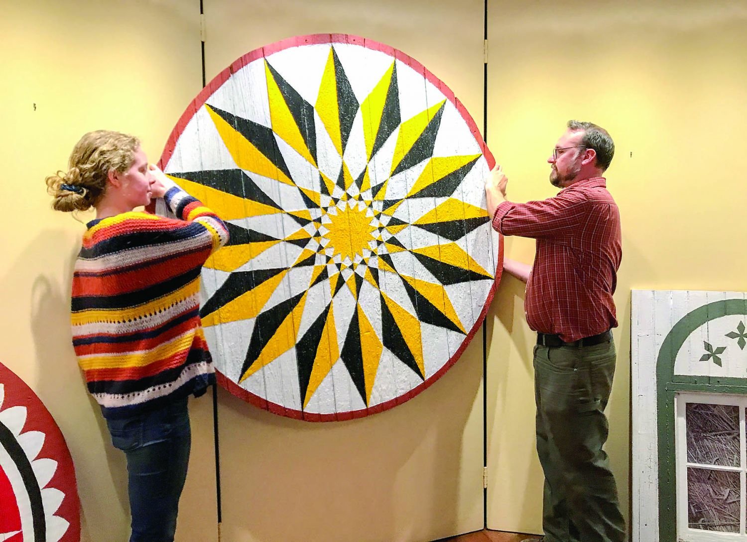 Patrick Donmoyer, guest curator, and student Sarah Edris plan the installation of a large barn star, which Edris restored under Donmoyer’s supervision.