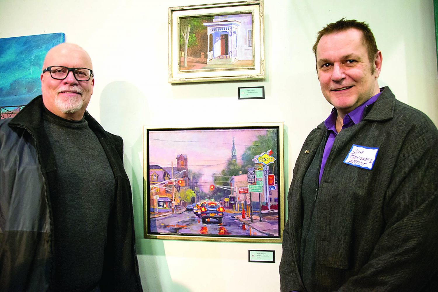Artist Jim Bongartz, with his painting at the bottom, “Skirting Lambertville,” and his partner, Kevin Mensch, both of Morrisville. Photograph by Chiara Chandoha.