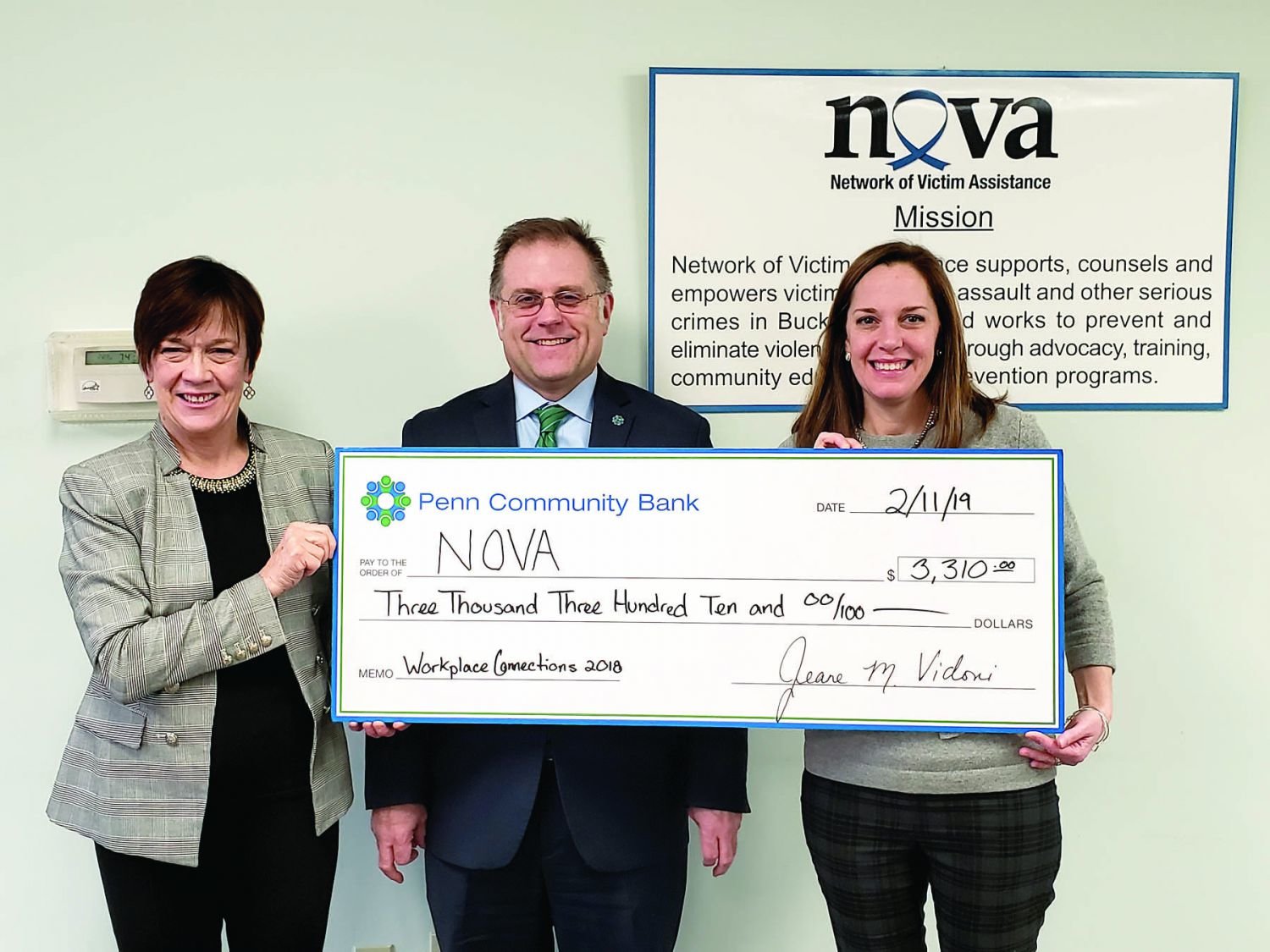 Todd R. Hurley, chief relationship officer, Penn Community Bank, center, presents a $3,310 donation to Penny Ettinger, Network of Victim Assistance (NOVA) executive director, left, and Mandy Mundy, NOVA senior director - Programs and Services.
