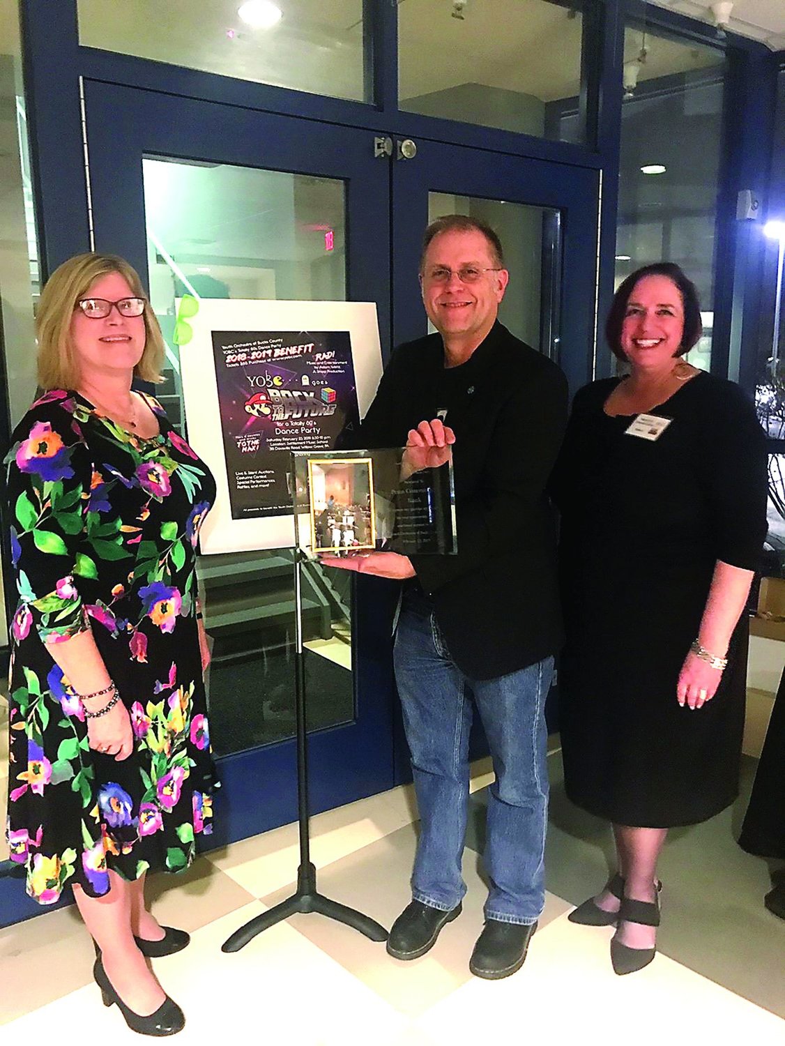 Penn Community bank executives, Diane Brown, chief administrative officer; Todd Hurley, chief relationship officer; and Stephanie Schwartzberg, general counsel, accept the award from the Youth Orchestra of Bucks County during its annual benefit.