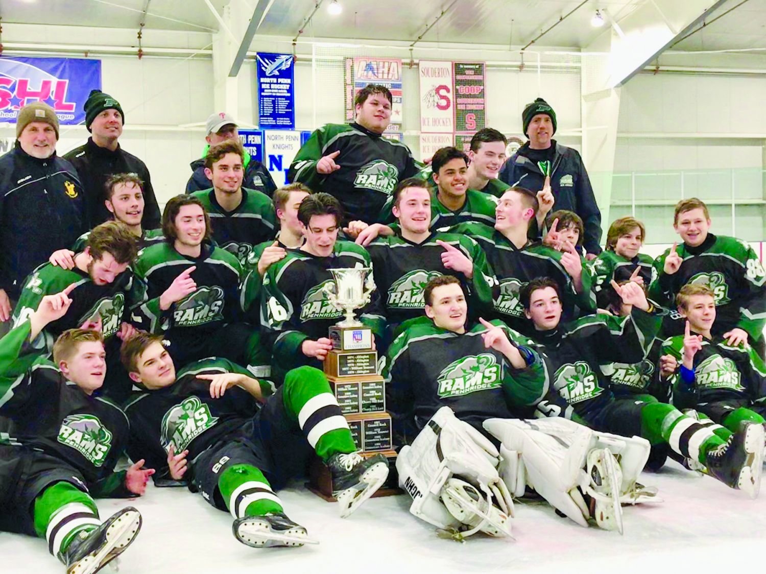 Pennridge players pose with the Suburban High School Hockey League trophy after winning their first league title in 11 seasons.