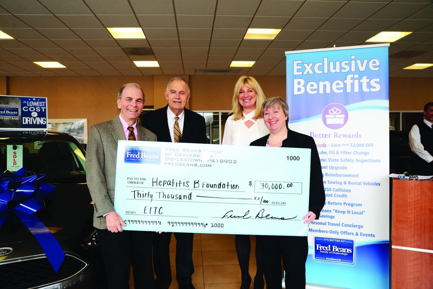 Fred Beans and Beth Beans Gilbert, center, present the $30,000 donation from the Fred Beans Family of Dealerships in support of the Hepatitis B Foundation’s High School Science Enrichment Program to Dr. Timothy Block, president of the foundation, left, and Jean Holmes, vice president of institutional advancement, right.