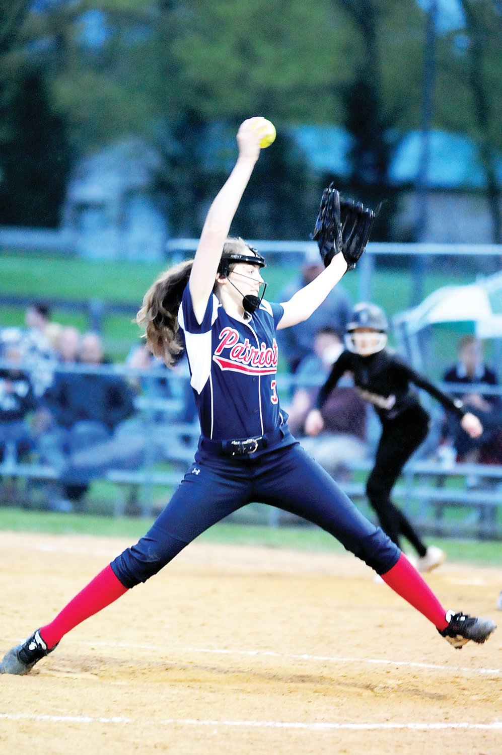 CB East junior right-hander Camille Larson, right, pitches for the Patriots. Photograph by Steve Sherman.