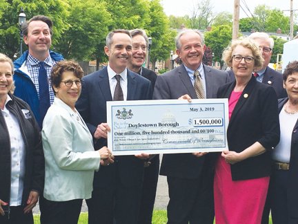 tate Sen. Steve Santarsiero, Doylestown Borough Mayor Ron Strouse, state Rep. Wendy Ullman hold the ceremonial check for $1.5 million from the state to help develop a new municipal complex on Broad Street in the borough.