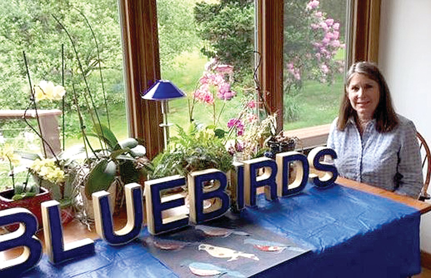 Johanna Chehi is fascinated by bluebirds, and checks their nesting boxes from the wide windows in her Durham home. Photograph by Kathryn Finegan Clark.