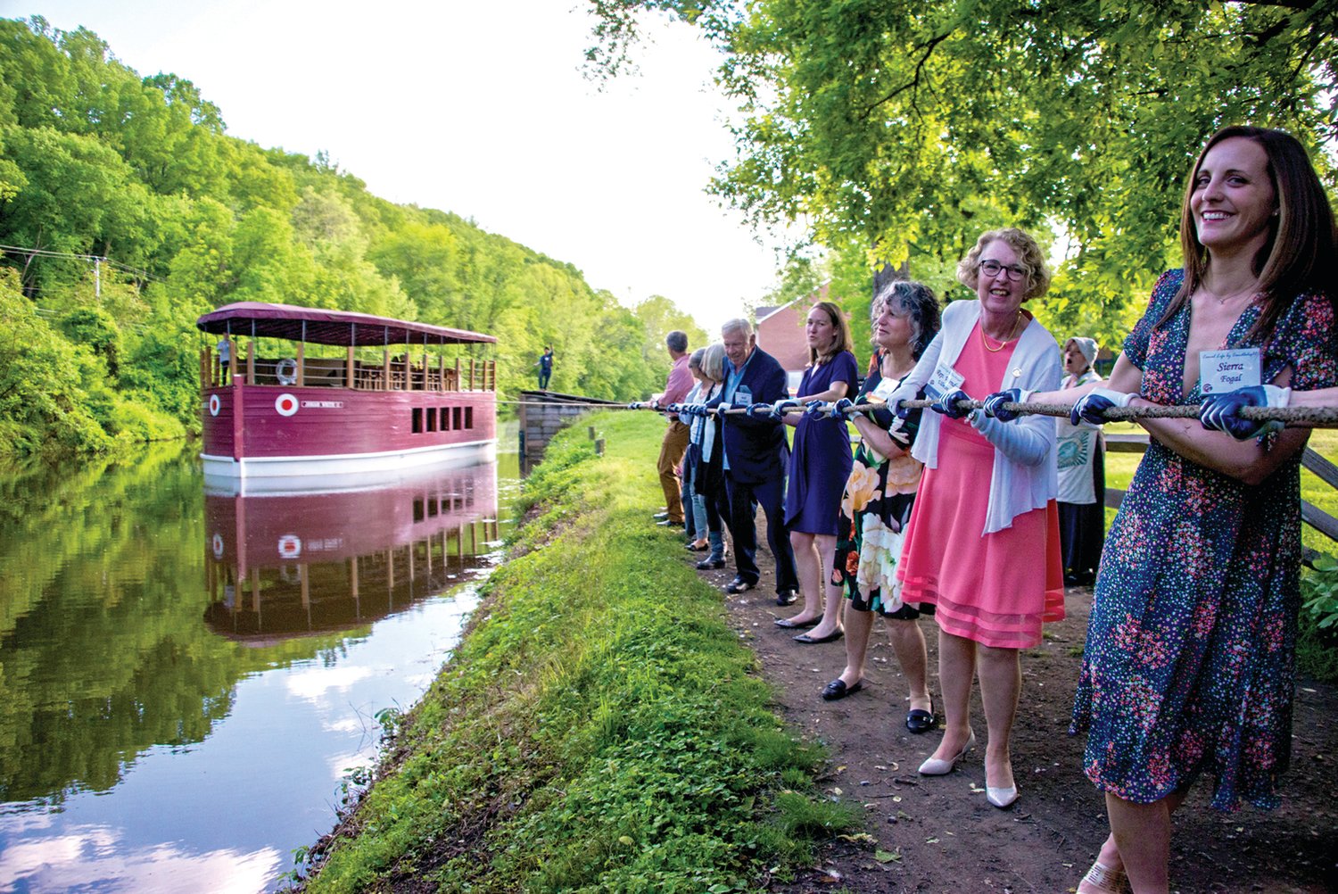 Sierra Fogal, board vice chair, and state Rep. Wendy Ullman and other guests see what it is like to pull the canal boat.  Photograph by Chiara Chandoha.
