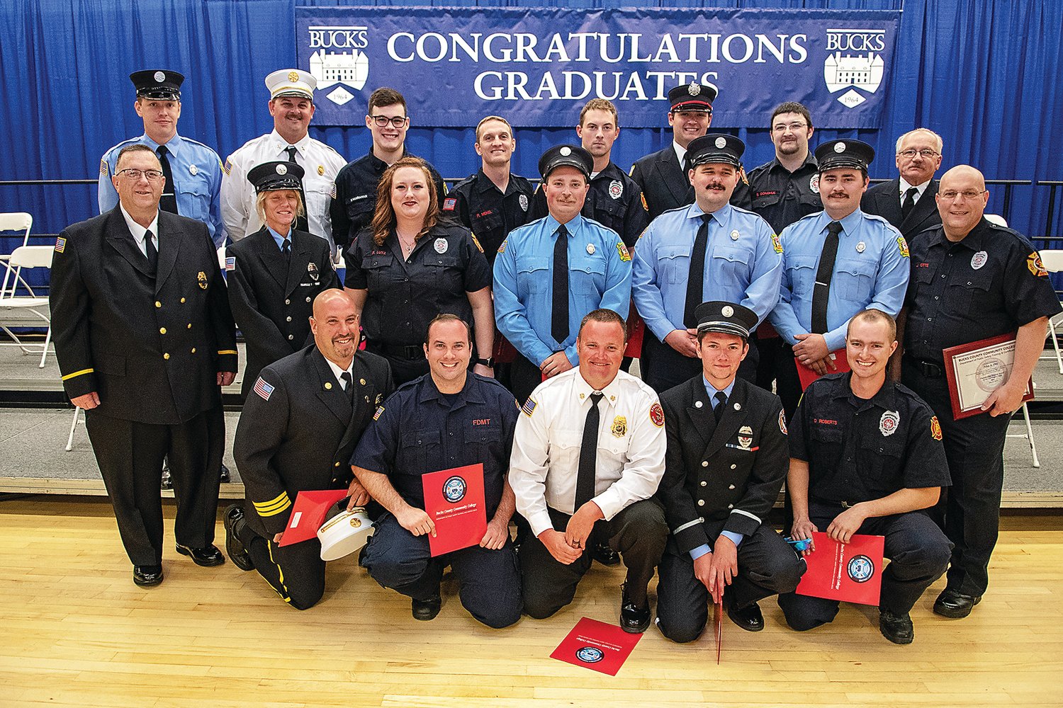 Bucks County Community College’s Public Safety Training Center held a graduation ceremony May 21 at the Newtown campus for 100 firefighters, including this class that completed Fire Fighter 2 national certification training at the Ottsville Fire Company. Instructor Robert Grunmeier, left, middle row, the center’s executive director, named John Otte, right, middle row, of the Hilltown Township Volunteer Fire Company, as outstanding student.