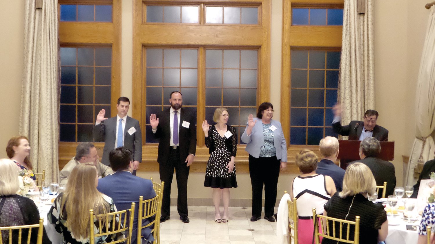 Christopher Carroll, second from left, and Dorothy Jaworski, far right, are installed as treasurer, president of Financial Managers Society Philadelphia Chapter.