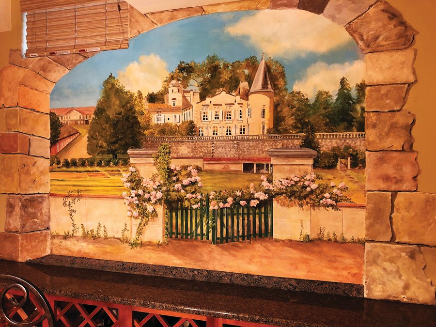 This award-winning trompe l’oeil mural depicting the Chateau Lafite Rothschild winery in Bordeaux, France, is by Michael Colkett and Cynthia Back.