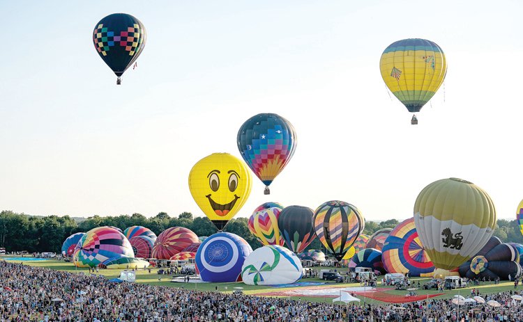 Crowds watch as hot air balloons take to the sky at the QuickChek New Jersey Festival of Ballooning. The three-day festival returns to Hunterdon County July 26 to 28.