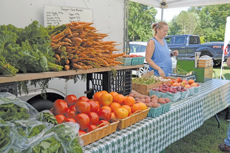 Rachel Roney is at the Trauger’s Market farm stand at last week’s New Britain Farmers Market in New Britain.