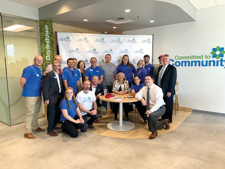 Penn Community Bank team members celebrate the opening of the Doylestown branch with former Phillies pitcher and current Phillies commentator Ricky Bottalico, center, during a “Hello Doylestown” event on July 25.