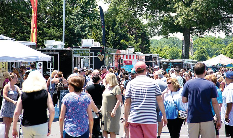 Attendees at a prior Food Truck Fest look over the dining choices. The Summer Send-Off event is Sept.