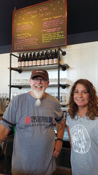 Co-owners Troy Reynard and Judy Nelson stand in front of their grand opening beer lineup Aug. 30 during a ribbon cutting of the Two Rivers Brewing Company Quakertown Taproom. It’s the first business open inside the Trolley Barn Public Market on East Broad Street.