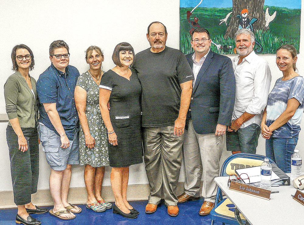 Standing with police chief emeritus Al Kurylka, center, are, from left, council members Holly Low, Tami Peterson, Liz Johnson and Michele Liebtag; Mayor Brad Myhre; and council members William Sullivan and Caroline Scutt.