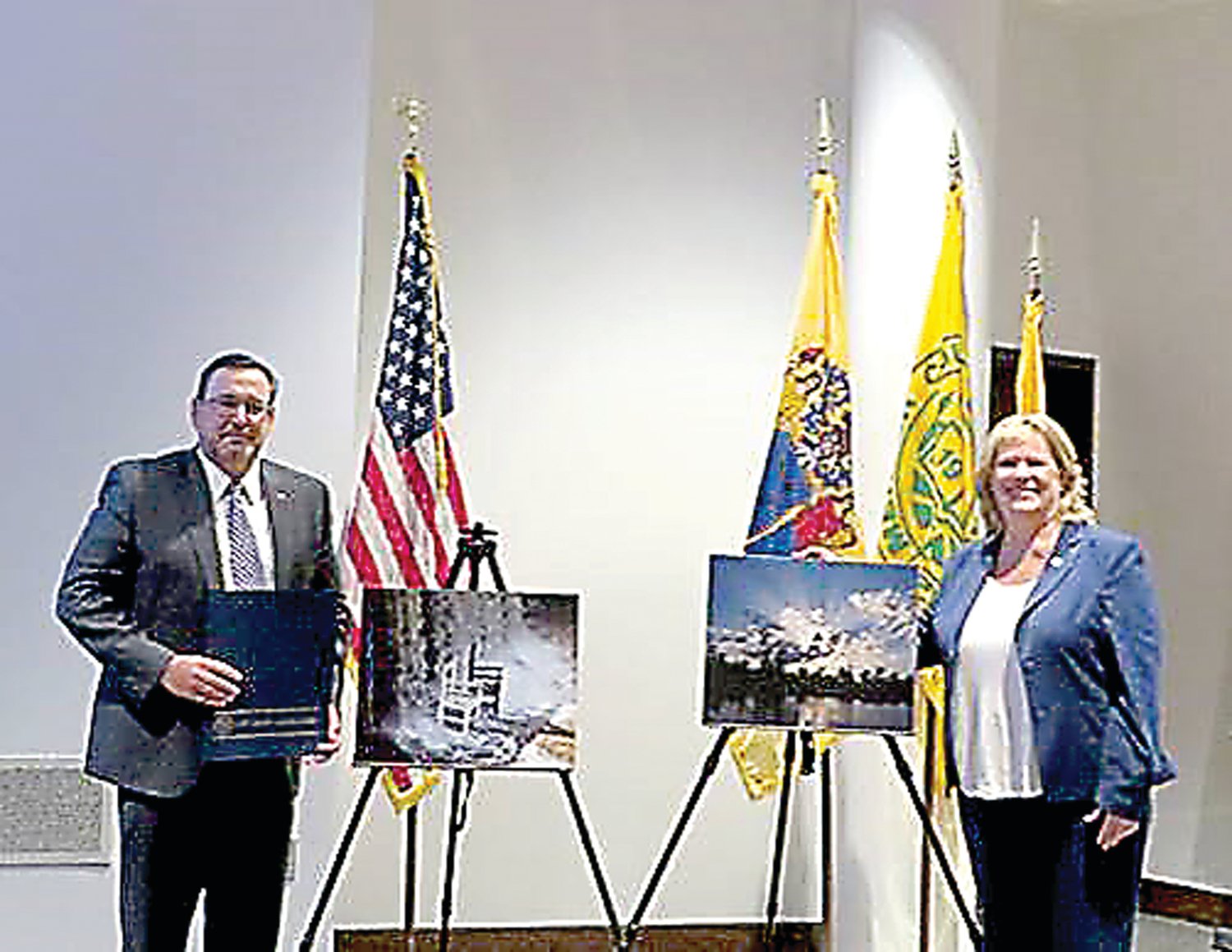 DRBC Executive Director Steve Tambini and Assemblywoman Carol Murphy (NJ-7) pose with the winning photos at DRBC’s meeting, held Sept. 11, at The Conference Center at Mercer, West Windsor, N.J.