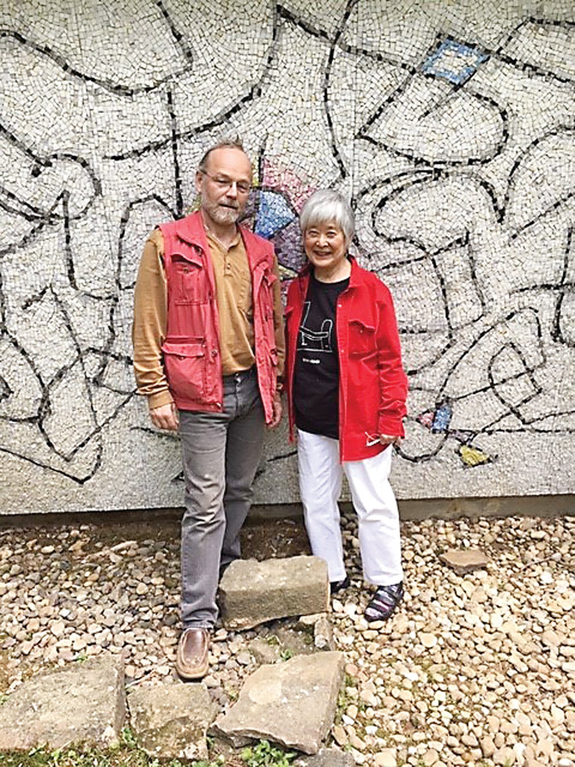 Vladimir Aituganov, master mosaic artist, left, and Mira Nakashima, president of the Nakashima Foundation for Peace, stand in front of the Ben Shahn mosaic.