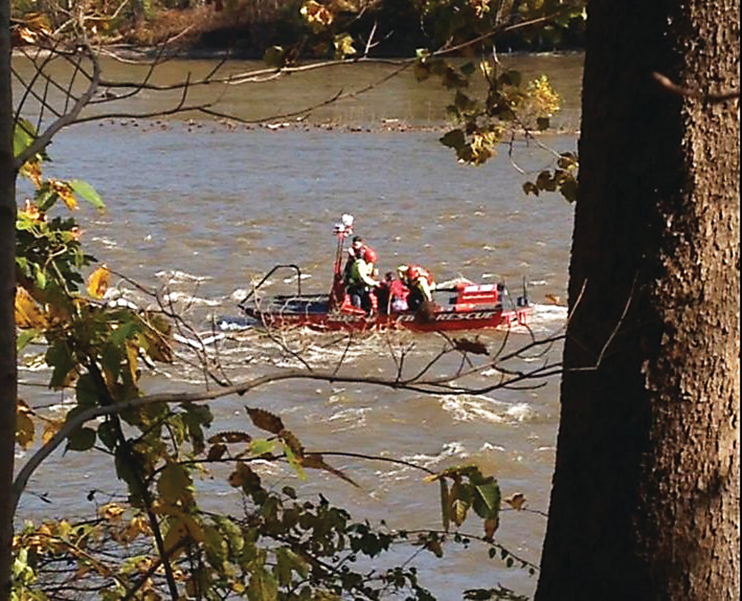 Firefighters from Delaware Valley Fire Co. rescue a woman clinging to a tree branch in the Delaware River in Erwinna. Photograph from a video by Carol Staudenmayer