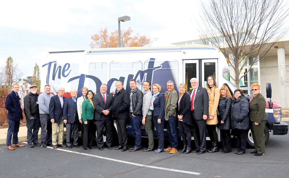 The Dart Bus Committee saw the new Dart West bus at Delaware Valley University Nov. 22. From left are Christian Regosch, Bill Shelly, Bucks County Transport CEO Jim Raymond, Chair Lou White, Bucks County Transport President Vince Volpe, Doylestown Township Supervisor Chair Barbara Lyons, DelVal President Maria Gallo, Rep. Todd Polinchock, Mayor Ron Strouse, Shawn Curran, Andrew Moyer, Rep. Wendy Ulman, Jim Sanders, Lisa Schwartzer,  Jack O’Brien, Samantha Bryant. Linda McNeill, Doylestown Township Manager Stephanie Mason and Eileen Brady. Mercer Museum Vice President Beth Ann Rinkus and Doylestown Borough Manager John Davis were not able to attend the meeting.  Photograph by Carol Ross.