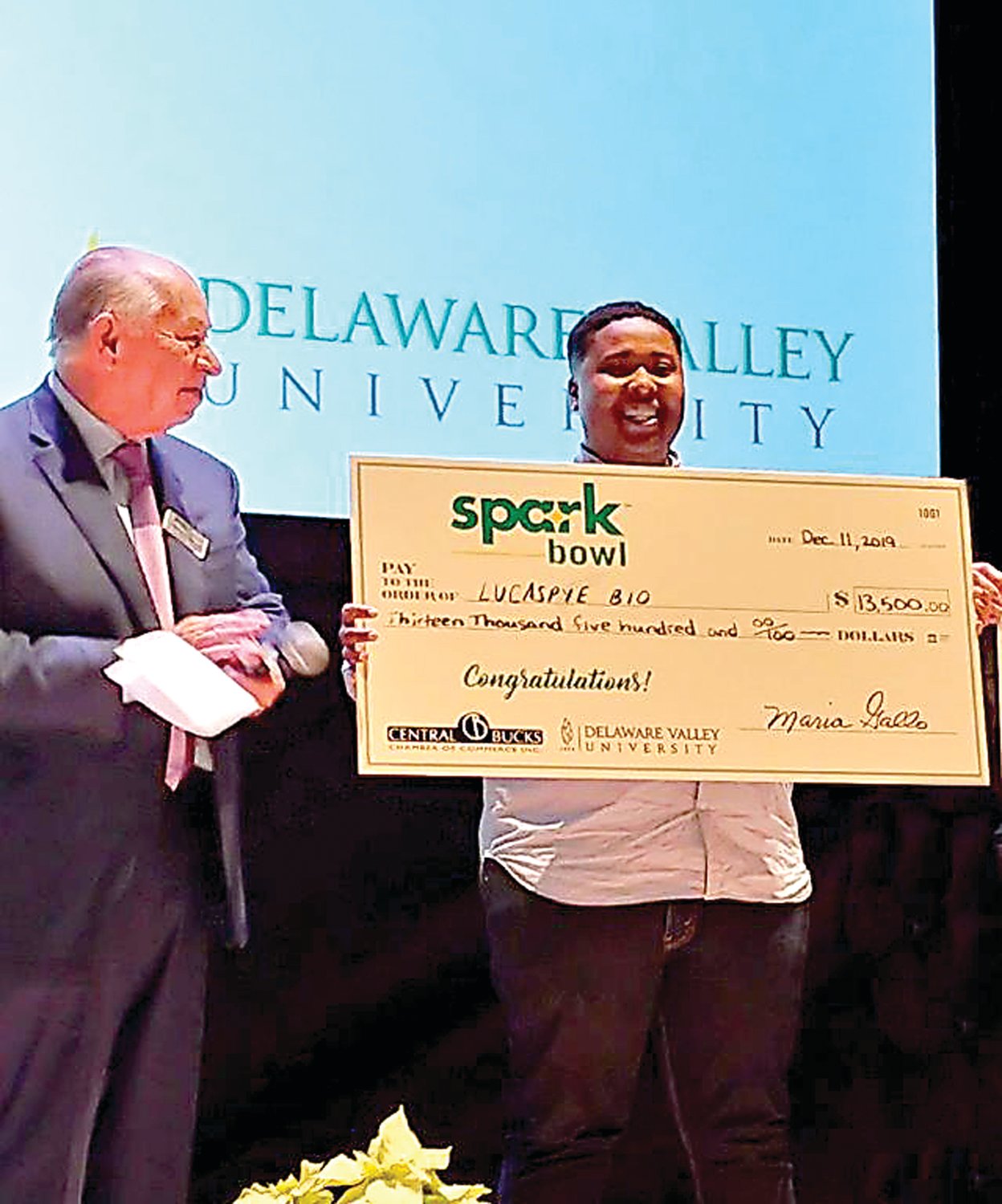 A check for $13,5000 is presented to SparkBowl winner LucasPye BIO.