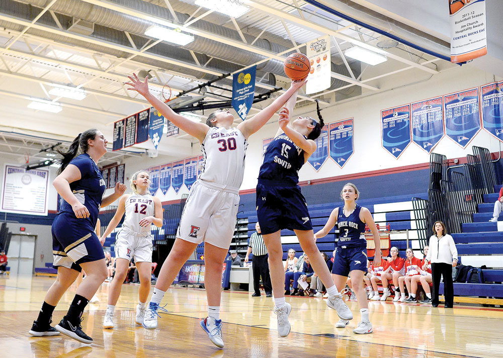 Central Bucks East’s Emily Chmiel grabs a rebound during the Patriots’ 57-34 victory over Council Rock South. Photograph by Michael A. Apice