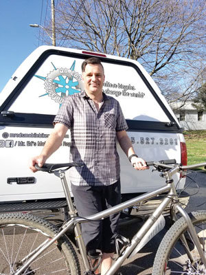Ed Hall, owner of Mr. Ed’s Mobile Bike Repair, considered an essential business, is continuing to visit clients.