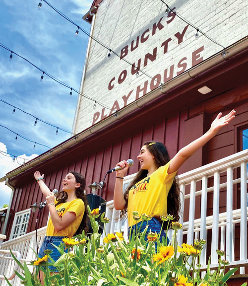 Sisters Sierra and Anna Shea Safran sing to the crowd in the Bucks County Playhouse courtyard.