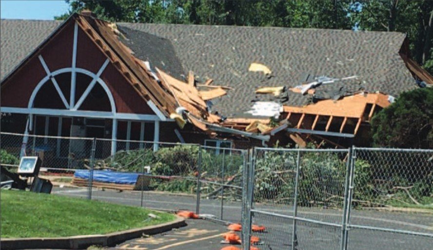 Doylestown Hospital’s day care center’s roof was damaged as Tropical Storm Isaias tore through Central Bucks County Tuesday. Frightened teachers and children were evacuated, no one was injured. Above, winds damaged a tree on the Doylestown Hospital campus.