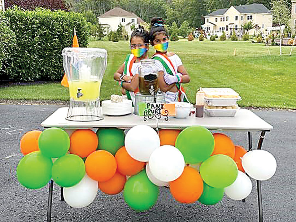 From left: Kaira Rao and Riyana Parikh set up a lemonade and Indian food stand to raise funds for Hunterdon Medical Center. The girls donated $260 to the Hunterdon Healthcare Foundation.