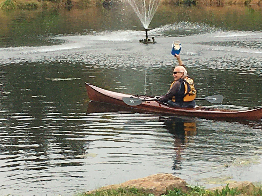 Lou Metzger, 80, launches the kayak he made at Pine Run Retirement Community, where he and his wife, Pat, live. The Metzgers have kayaked all over the world. (Freda Savana)