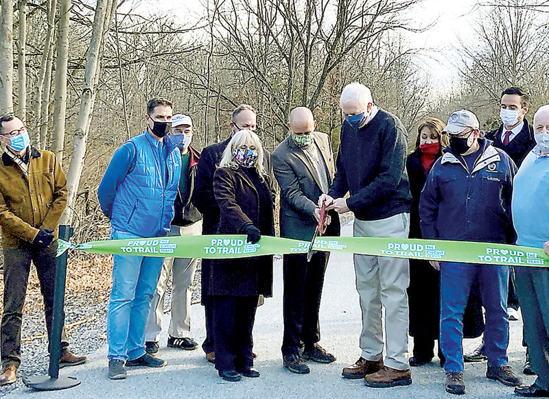 Local and county officials cut the ribbon officially opening the Upper Bucks Rail Trail. Included in the group are, from left, Patrick Starr of the Circuit Trails Coalition and the PA Environmental Council, Thomas Marino, chair of the Richland Township Park & Recreation Board, Frank Hollenbach of the Springfield Township Parks & Land Preservation Board, Evan Stone, executive director of the Bucks County Planning Commission, County Commissioner Chair Diane Ellis-Marseglia, Richard Brahler, director of transportation planning for the Bucks County Planning Commission, Paul Gordon, senior transportation planner for the Bucks County Planning Commission, Kathie Doyle, Richland Township supervisor, Tim Arnold, Richland Township supervisor, Kyle Melander of Congressman Brian Fitzpatrick’s Office, and former County Commissioner Charley Martin.