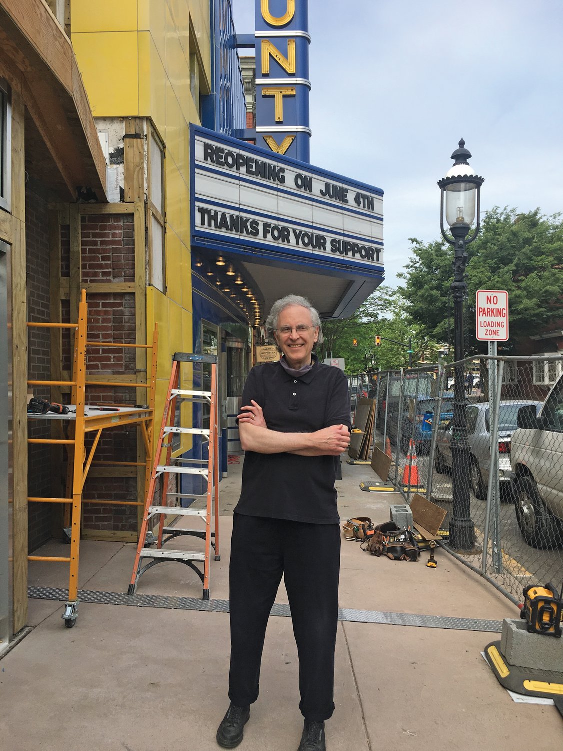 John Stoner, founding director of the County Theater, stands outside the iconic movie house in Doylestown ,where the marquee advertises the planned June 4 reopening.