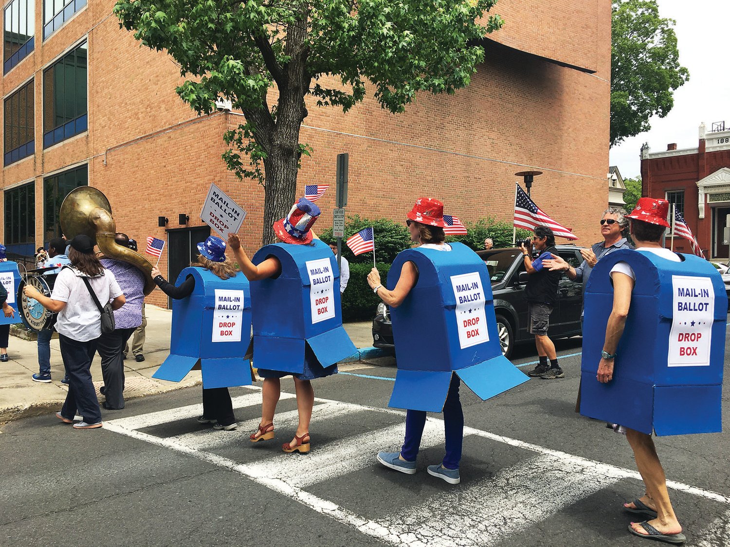 Members of Bucks Voices dance their way to the former Bucks County Courthouse to call for more drop boxes in Bucks County.
