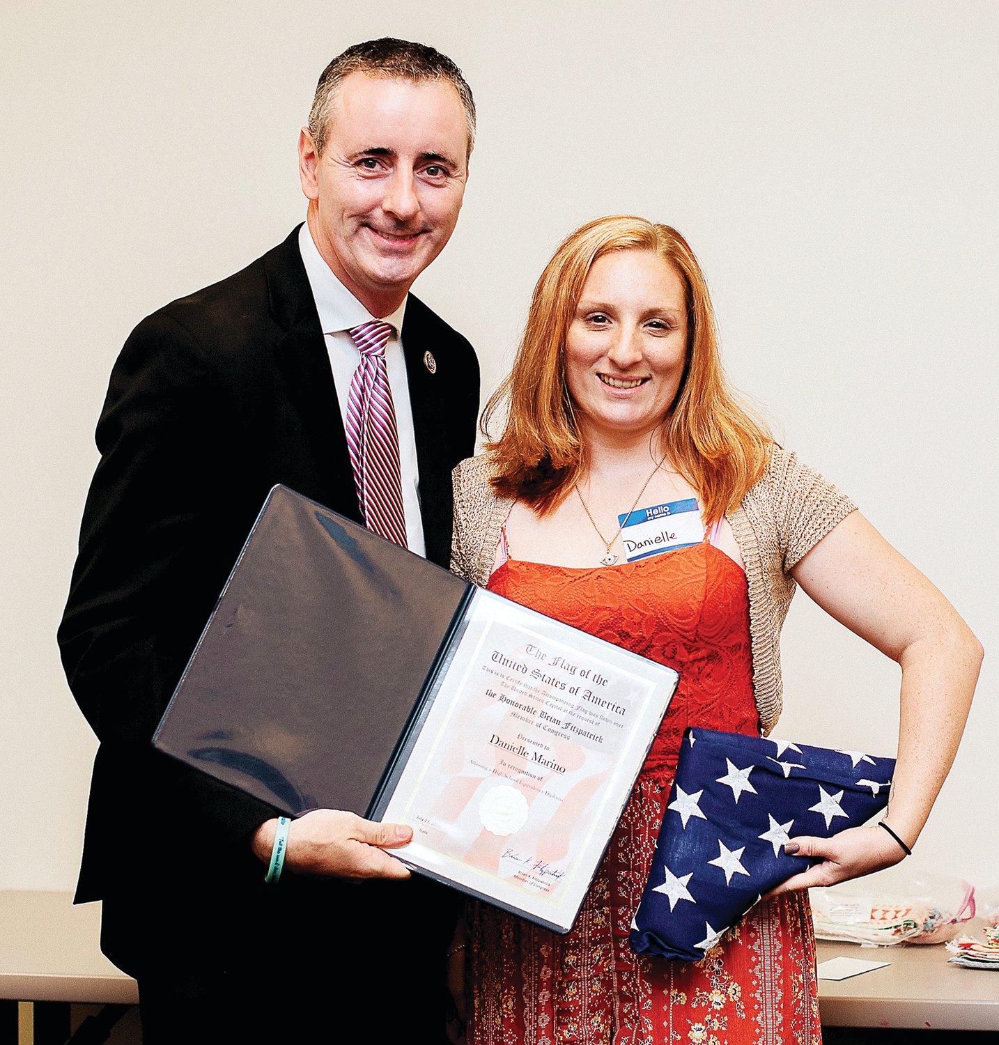 U. S. Rep. Brian FitzPatrick, R-Bucks, presents a citation and U.S. Flag to a Vita student in recognition of achieving her High School Equivalency diploma.