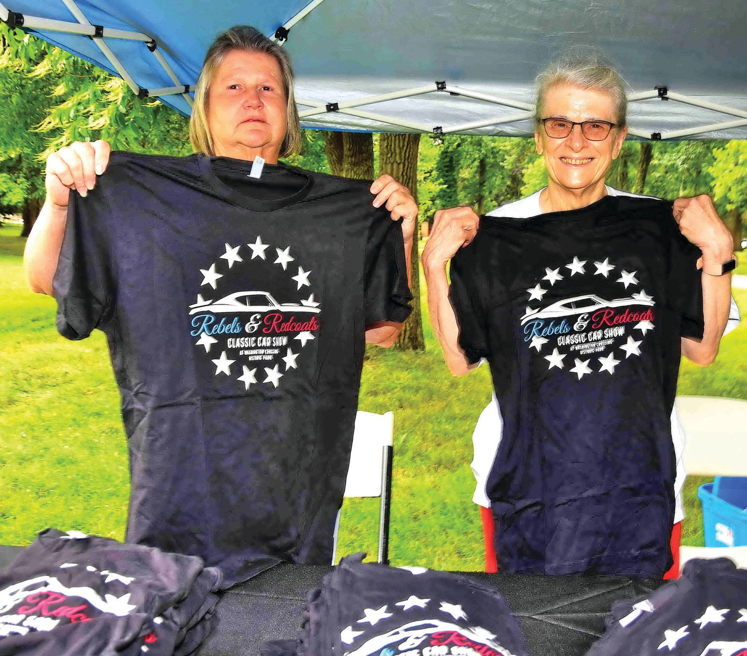 Volunteers Linda Hendershot and Jeanne Barney sell the official show T-shirts.