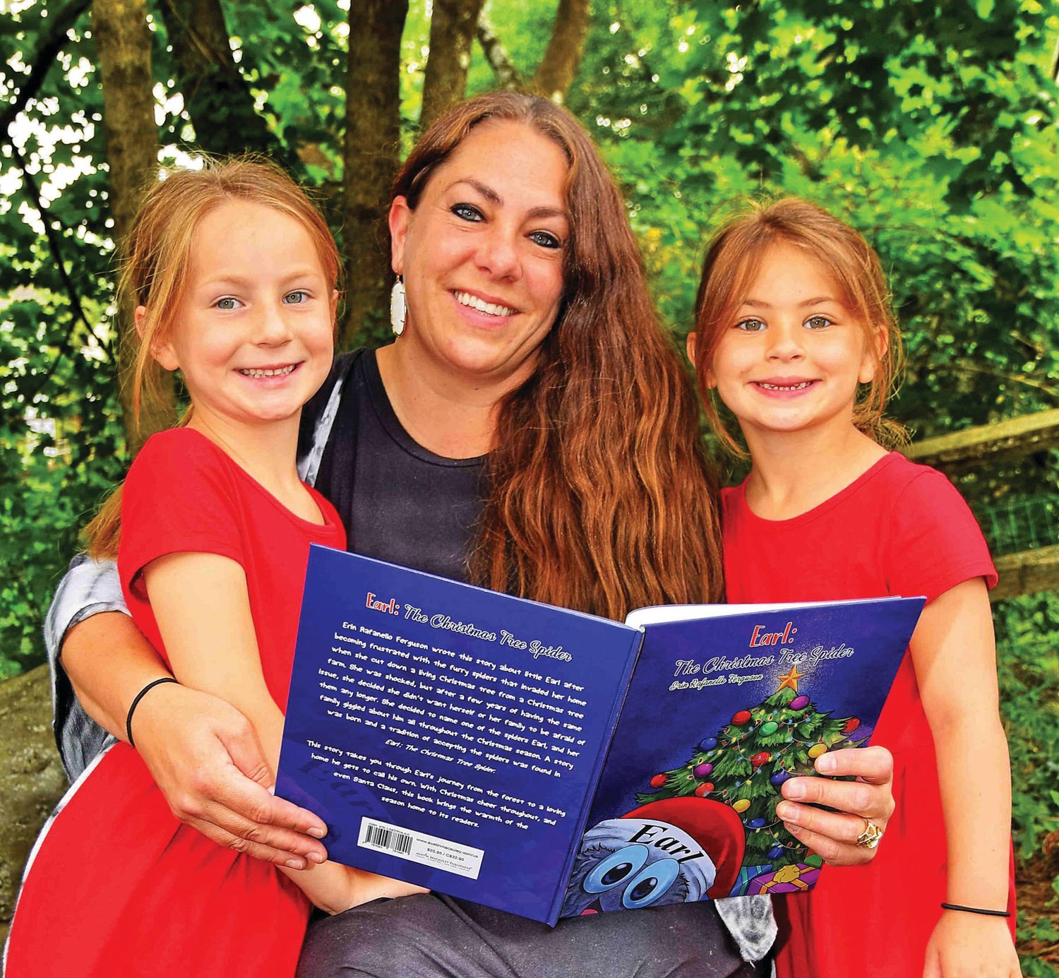 Author Erin Rafanello Ferguson reading from her book “Earl: The Christmas Tree Spider” to her children, Sawyer and Harlan Ferguson.